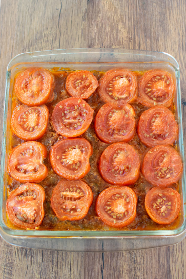 Israeli-Style Moussaka in a baking dish topped with tomatoes