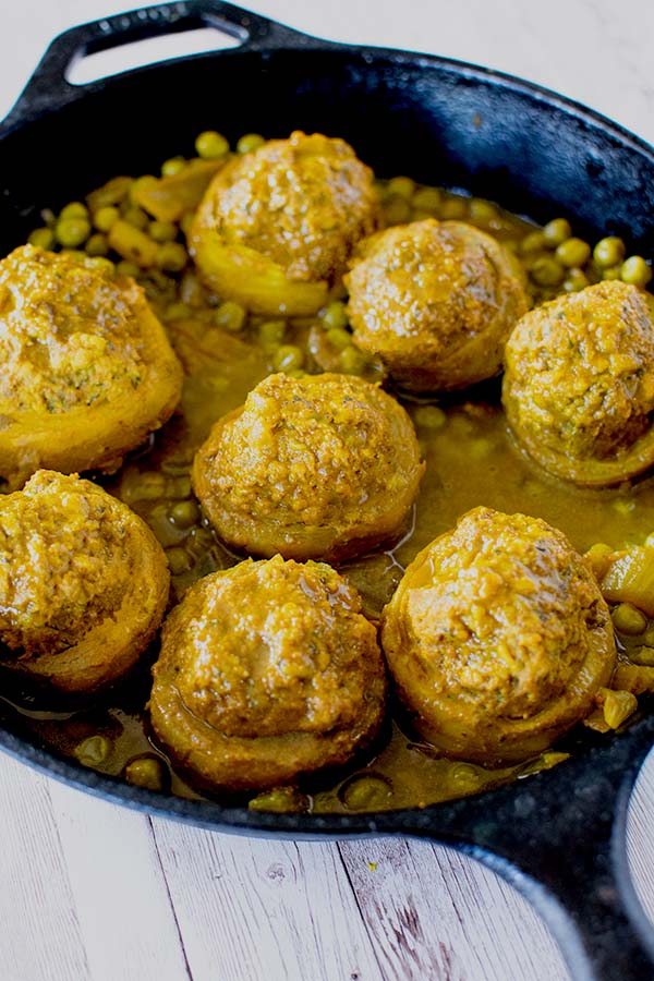 Stuffed Artichoke bottoms with peas in a cast iron frying pan