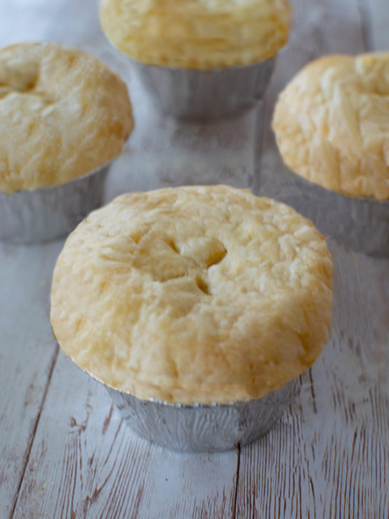 Dairy-free mini apple pies on a white wood background