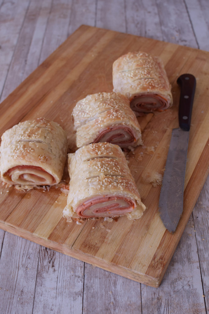Easy Deli rolls on a cutting board with a knive nearby