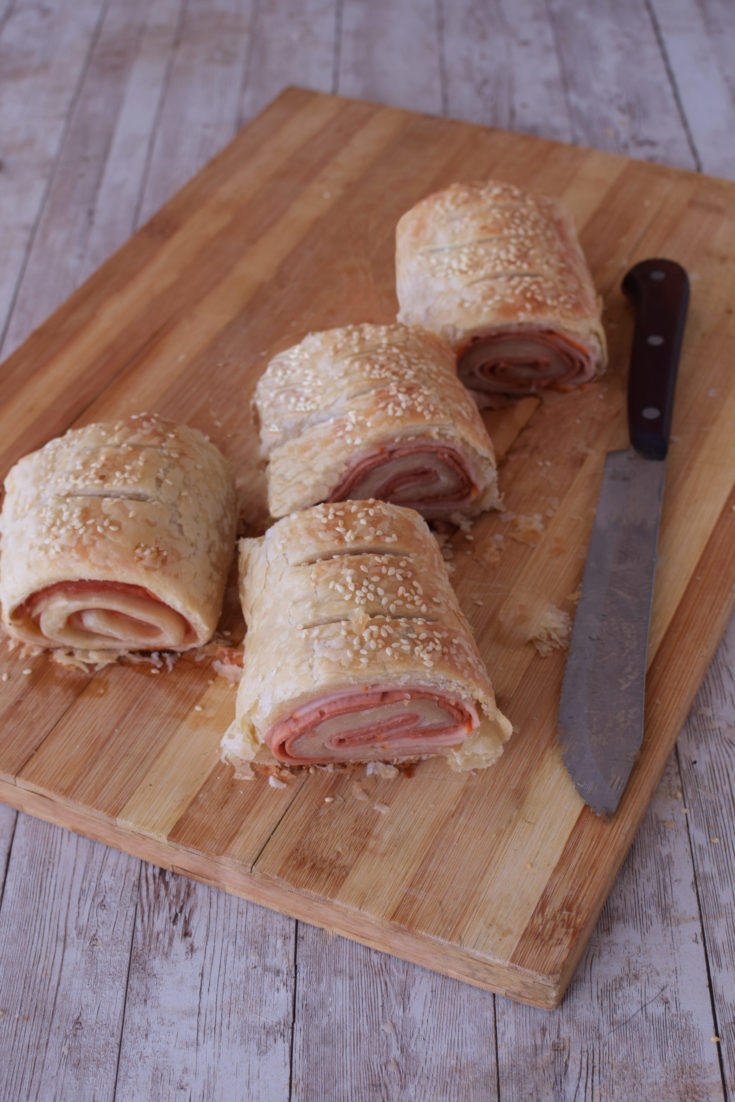 Easy Deli rolls on a cutting board with a knive nearby