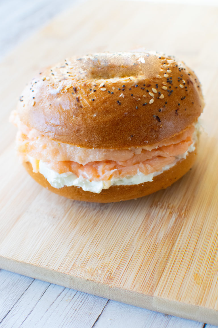 Easy Homemade Bagels with cream cheese and lox on a cutting board