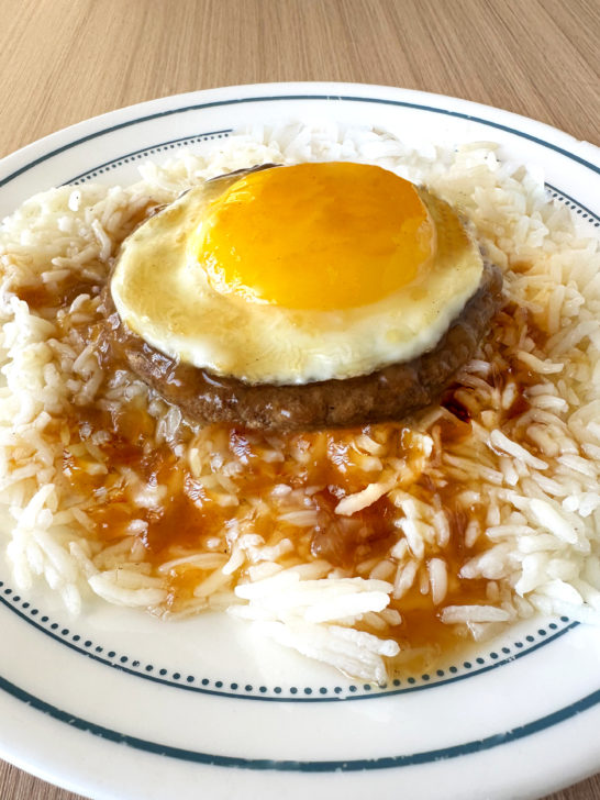 Vegetarian Loco Moco on a white plate on a light wood table