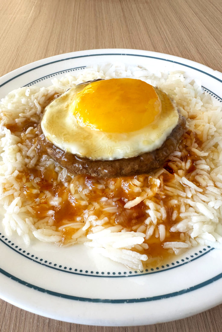 Vegetarian Loco Moco on a white plate on a light wood table