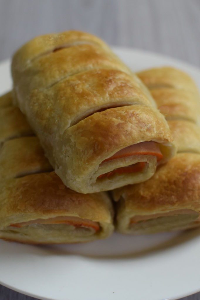 Personal Delli rolls on a white plate on a white wood table